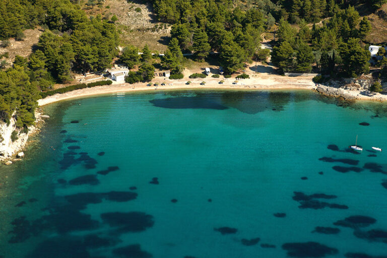 Milia: blue-green beach, hidden in a small bay in a dense pine forest.